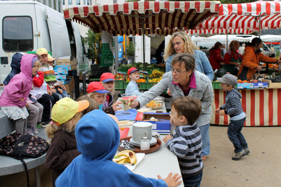 Frisch auf den Tisch: Mitten auf dem Wochenmarkt bereiteten sich die Kinder einen bunten Obstsalat zu und schmeckten ihn mit Honig ab.