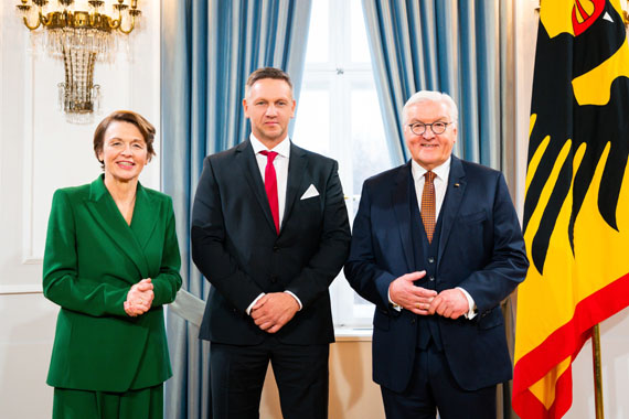 Das Bild zeigt drei Personen bei einer feierlichen Auszeichnung durch den Bundespräsidenten 